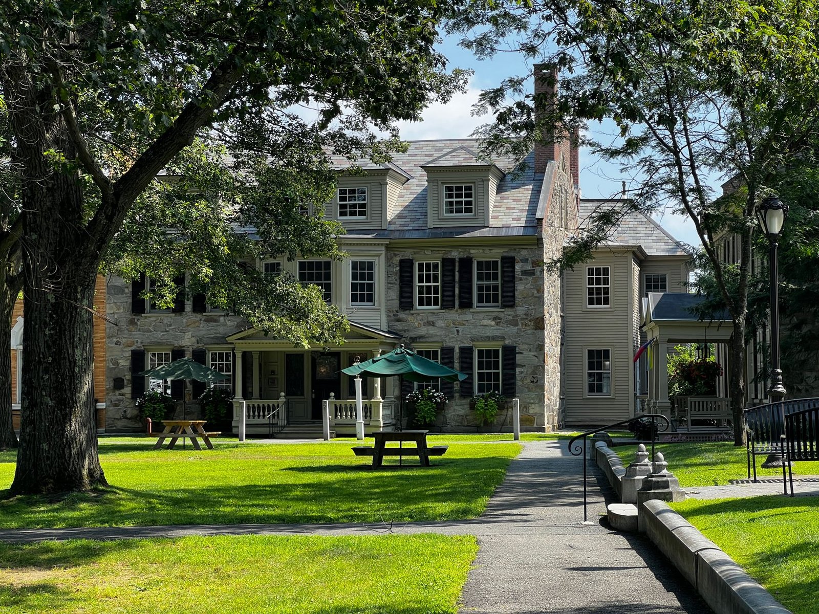 Colonial-style house surrounded by mature trees