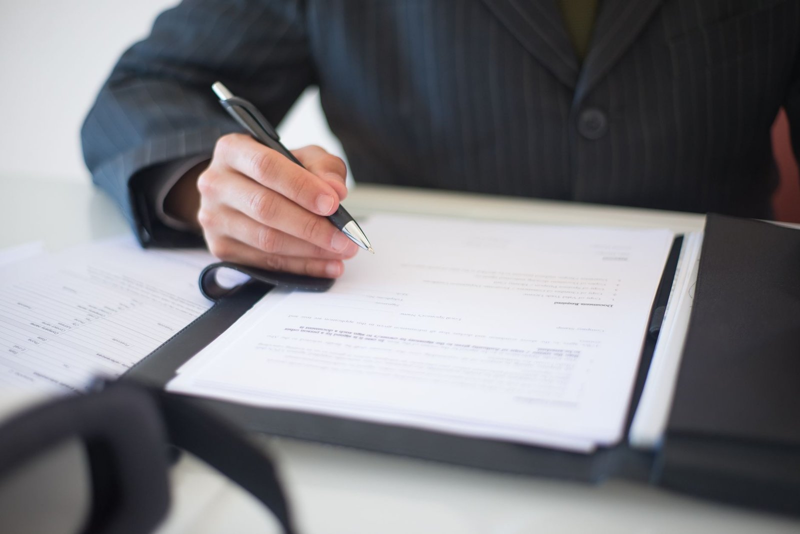 Close-up of a hand signing a document