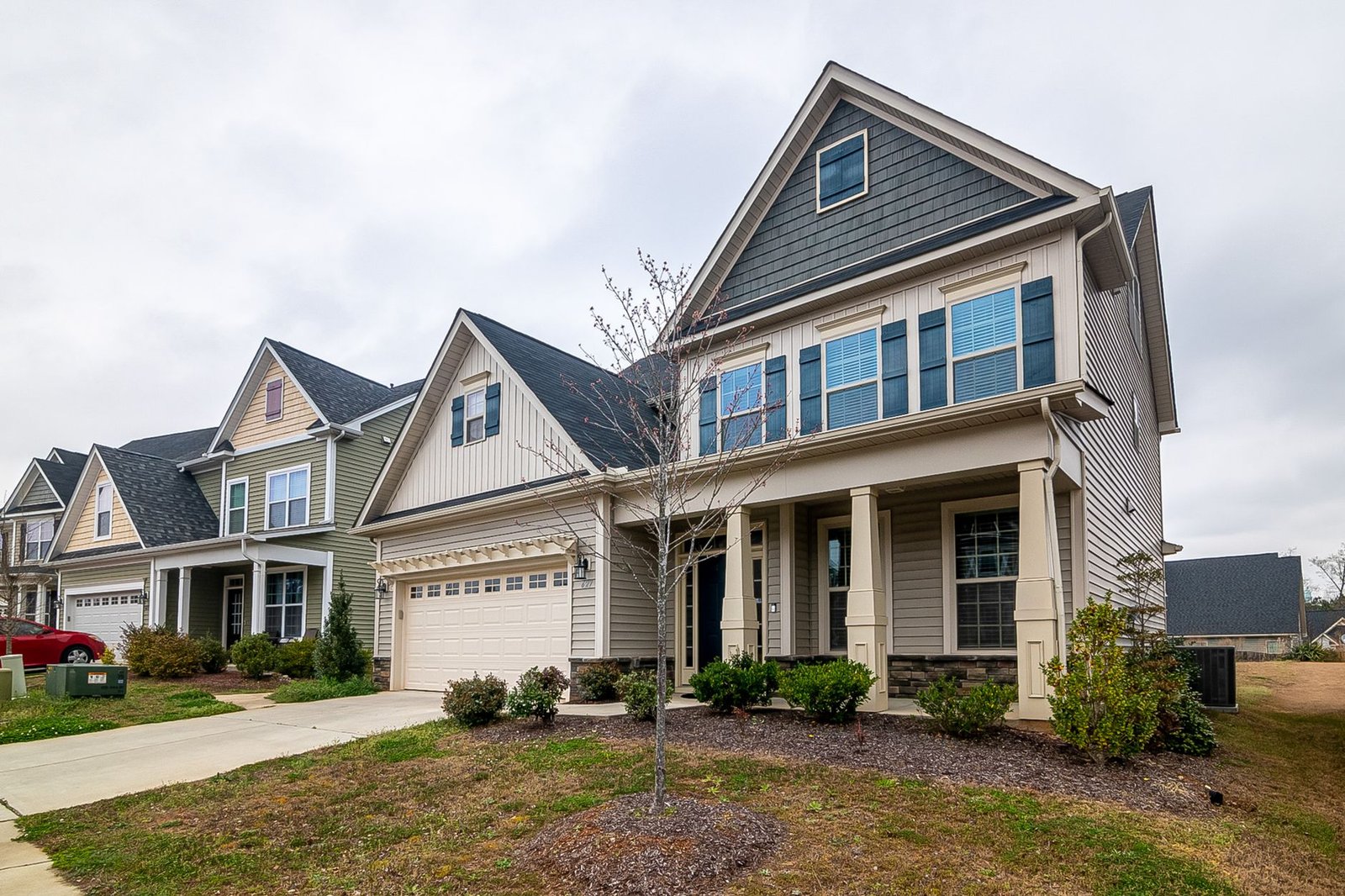 Row of suburban homes with driveways and landscaped yards